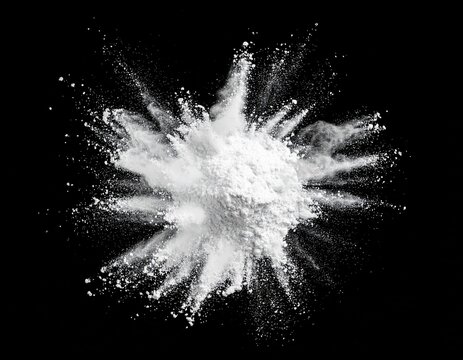 White flour powder bursting on a black background, overlay material with copy space