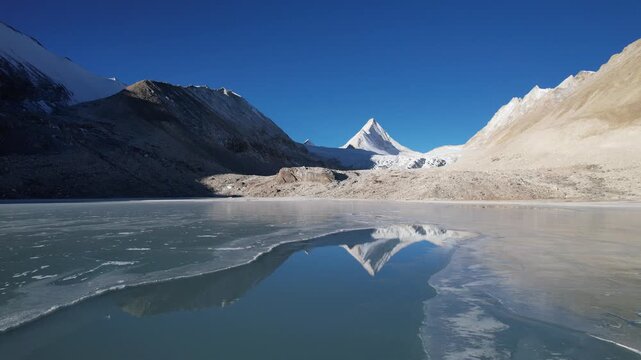 Aerial drone view of frozen lake and King Peak in Lunpo Gangri, Tibet