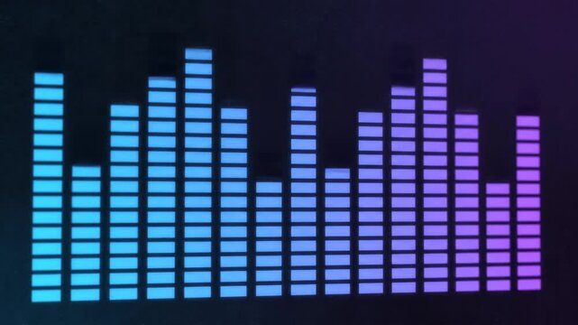 Pulsating audio equalizer bars with vibrant blue and purple gradient glowing on a dark background during a dynamic music visualization