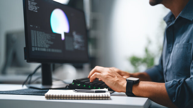 Close up hand typing keyboard of adult engineer latin man programmer coding AI artificial intelligence algorithm coder training monitor