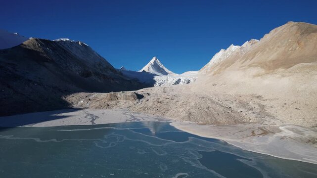Aerial drone view of King Peak and frozen lake in Tibet