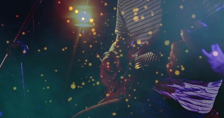 Obraz premium Playing guitarist wearing striped short-sleeve shirt on club stage, with electric guitar and mic