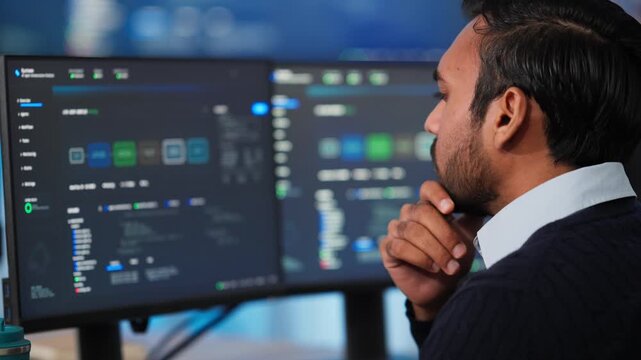 Thoughtful IT Programmer Analyzing Code on Dual Monitors at Night