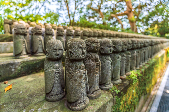 Stone Jizo statues in rows at Hase-dera temple in Kamakura Japan
