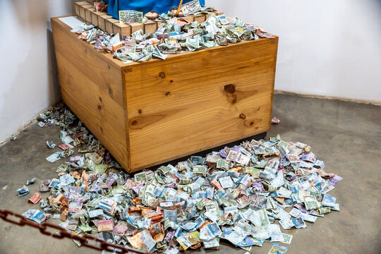 Wooden chest overflowing with banknotes