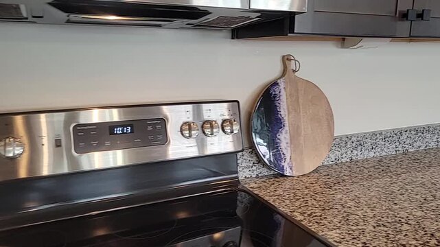 Modern kitchen with glass cooktop and granite countertop