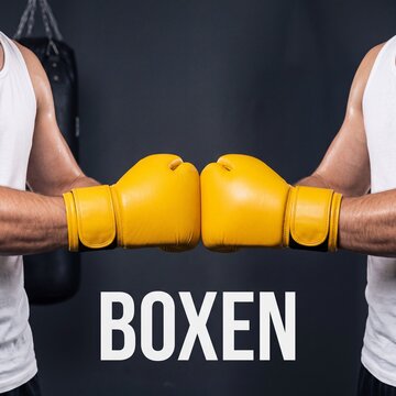 Boxen Boxhandschuhe treffen sich vor grauem Hintergrund im Fitnessstudio