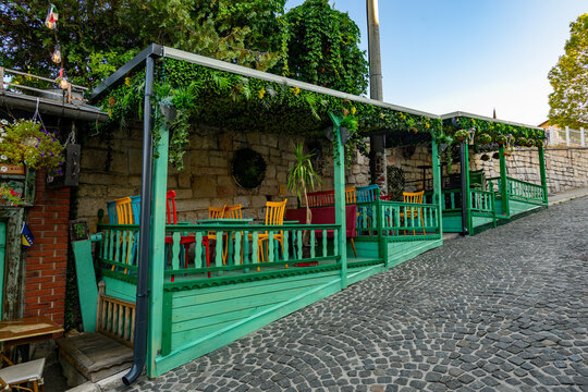 Sarajevo, Bosnia and Herzegovina - August 10, 2026: The charming green outdoor terrace of the Ministry of Cejf cafe, located on the sloping Kovaci street in the historic old town of Sarajevo