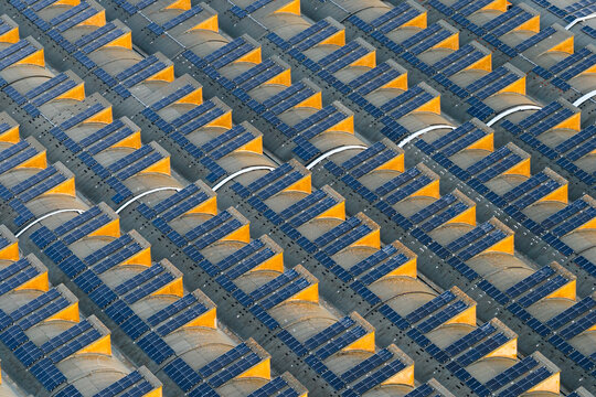 Aerial view of EUR district rooftops featuring repetitive arched structures and modern solar panel arrays in Rome, Lazio, Italy.