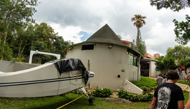 Damaged circular building exterior with damaged ramp and bystanders