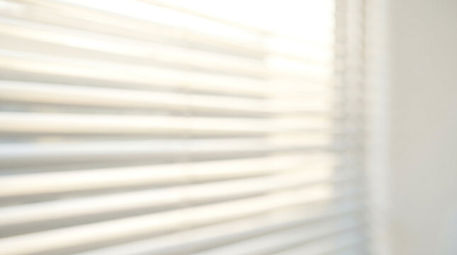 Blurry image of a room with a window looking out to a cityscape through a white interior