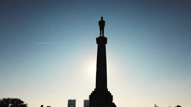 The majestic Victor Monument stands tall at Kalemegdan Fortress, silhouetted against a colorful sunset sky in Belgrade, symbolizing triumph and history at this significant location