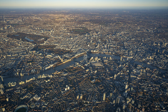 Aerial view of the sprawling cityscape of London featuring the River Thames, the London Eye, and dense urban architecture in London, England, United Kingdom.