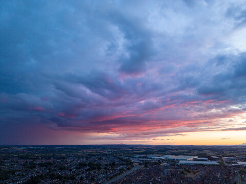 Aerial view of the town of Stafford at sunset with dramatic clouds over residential areas and industrial buildings in Stafford, England, United Kingdom.