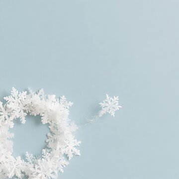 Large drifting snowflake breaking away from a circle of ice crystals, featuring a frosty texture on a slate-blue background for winter greeting design and copy space