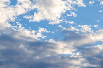 Obraz premium Fluffy white clouds in a bright blue sky cumulus clouds sun light
