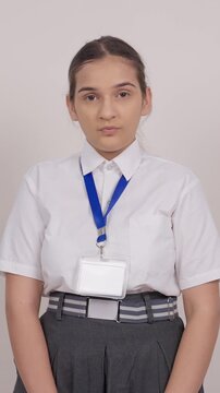 Vertical Shot of Indian Schoolgirl Shushing in Camera