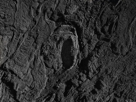 Aerial view of the dark volcanic landscape and textured lava flows of La Palma, Region of Murcia, Spain.
