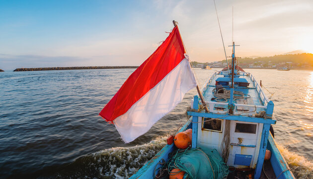 A boat sailing on water with a red and white flag at sunset.