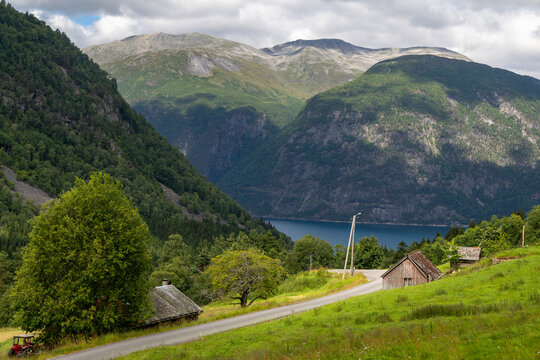 A beautiful gravel road in a village valley. A seasonal scenery of Eidsdal village in World Heritage area of Western Norway.