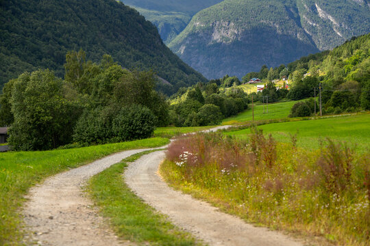 A beautiful gravel road in a village valley. A seasonal scenery of Eidsdal village in World Heritage area of Western Norway.