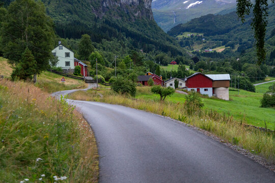 A beautiful gravel road in a village valley. A seasonal scenery of Eidsdal village in World Heritage area of Western Norway.