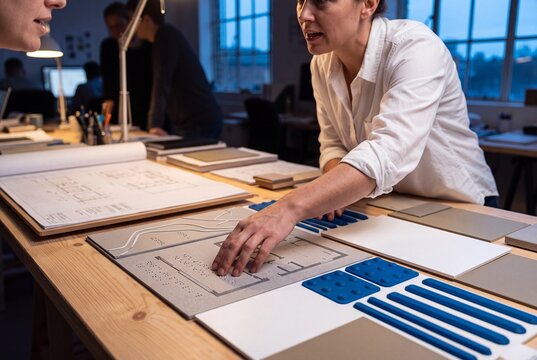 Architects Collaborating on Inclusive Design with Tactile Braille Floor Plans and Samples in Studio
