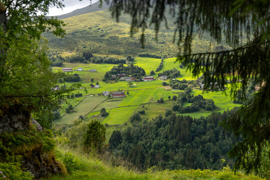 Beautiful green landscape of a hiking trail above the village. A seasonal scenery of Eidsdal village in World Heritage area of Western Norway.