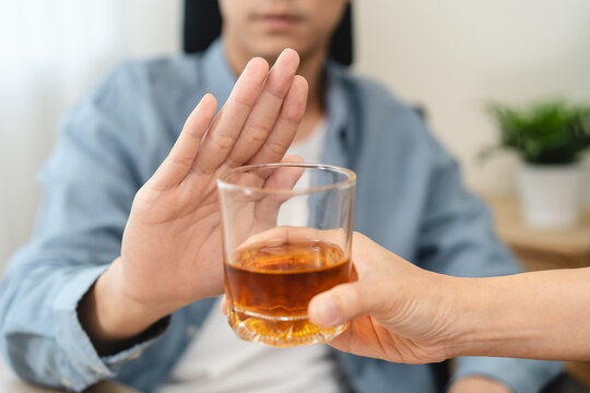 man refuse to drink alcohol say no to his friend.