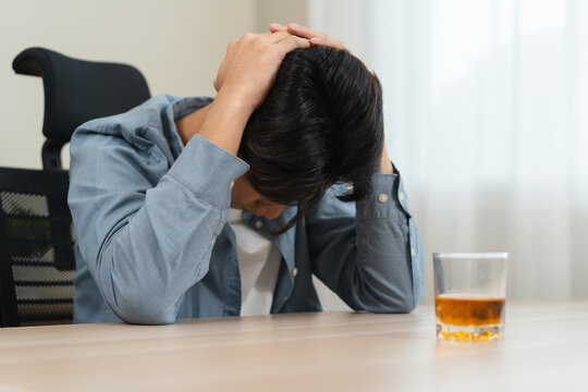 Alcoholism concept. Young man drinking alcohol too much.