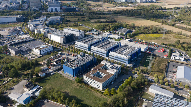 Aerial view of a modern business park with office buildings, warehouses, and parking facilities in Frankfurt am Main, Hessen, Germany.