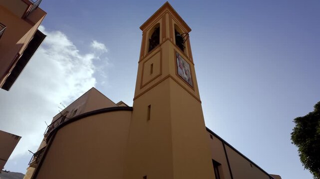Low-angle upward pan of church bell tower, Mondello, Sicily, Italy