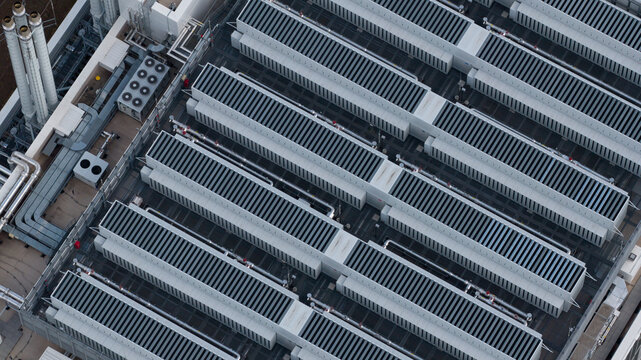 Aerial view of industrial rooftop with rows of cooling units and ventilation systems in Frankfurt am Main, Hessen, Germany.