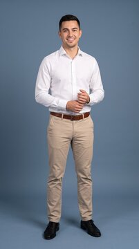 A professional studio shot of a man  Background is a seamless, solid slate blue studio backdrop. Soft, even lighting