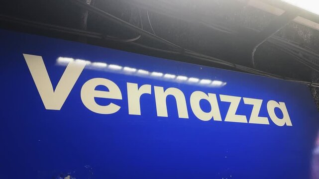 lue train station sign displaying 'Vernazza', located in the iconic village of Vernazza within Cinque Terre, Italy