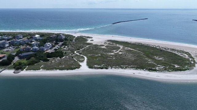 Scenic beach and coastline at Wrightsville Beach, NC with natural inlet waterway and sand dunes in summer