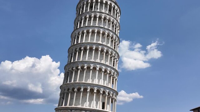 Leaning Tower of Pisa tilting against blue sky, Italy