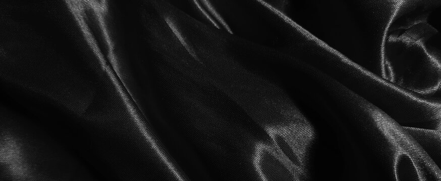 abstract background black luxury color satin fabric texture. glossy, grainy, and blurred concept.