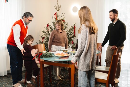 Multi-generational family celebrating christmas dinner at home