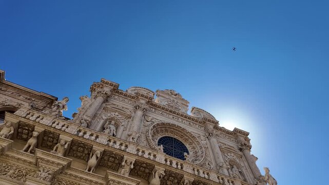 4K footage of the Baroque fa&ccedil;ade of the Basilica of Santa Croce in Lecce. A slow camera movement highlights the central rose window, while sunlight accentuates the Lecce stone.