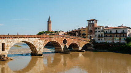 Fototapeta premium Exploring the enchanting Ponte Pietra bridge in Verona, Italy on a sunny day