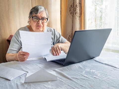Surprised Senior Woman Reacting to High Household Bill at Home