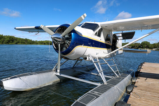 Small float plane designed to fly in remote Alaska bush takes off and lands on Alaskan river water for adventure.