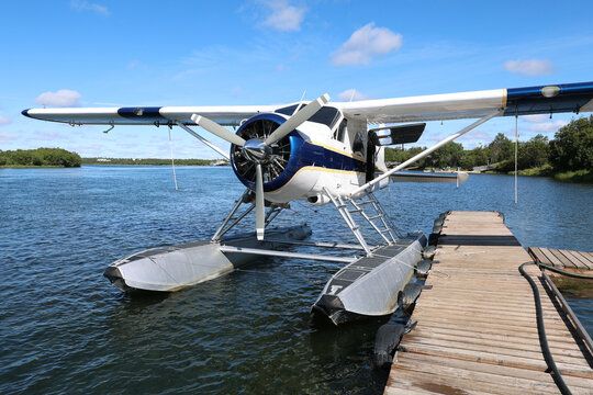 Small float plane designed to fly in remote Alaska bush takes off and lands on Alaskan river water for adventure.