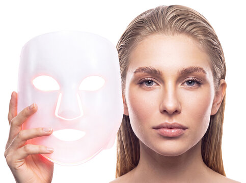 A woman wearing an LED facial mask. Professional skin care, rejuvenation, and innovative cosmetic technologies. Cut out background, PNG