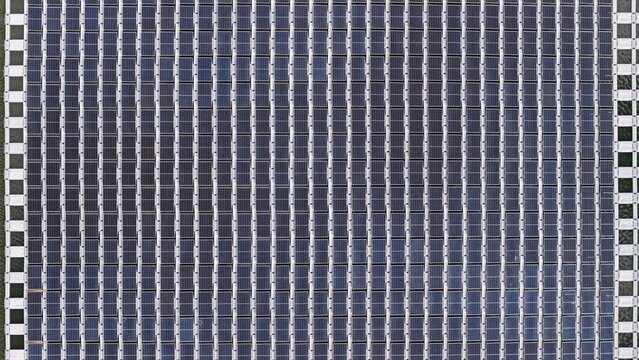 Aerial view of a floating solar farm with rows of photovoltaic panels arranged in a grid pattern on the water surface in Erie, Colorado, United States.