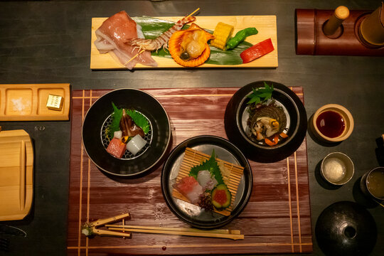Kaiseki dinner spread with assorted seafood dishes at Takefue ryokan, Aso District, Kumamoto, Japan
