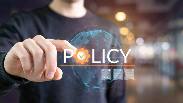 Hand interacting with a virtual display showing 'POLICY' with a gear and checkmark, representing digital governance and strategic global compliance