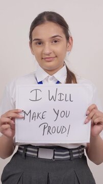 Vertical Shot of Indian Schoolgirl Standing with I Will make You Proude Poster