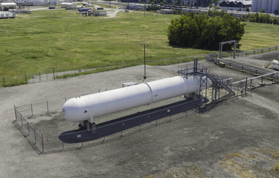 Aerial view of a large horizontal pressurized storage vessel at the Marathon Petroleum facility, surrounded by a chain-link fence in Nashville, TN, United States.